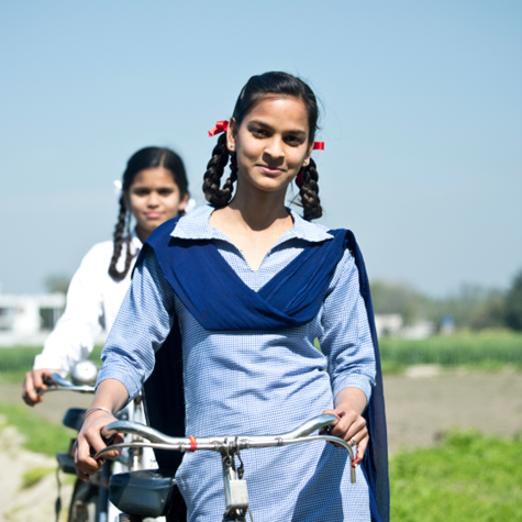 Two young girls in rural India with cycles