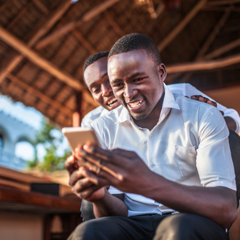 Young adults from Africa looking at a smartphone