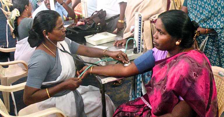 A woman's blood pressure being checked at a health camp