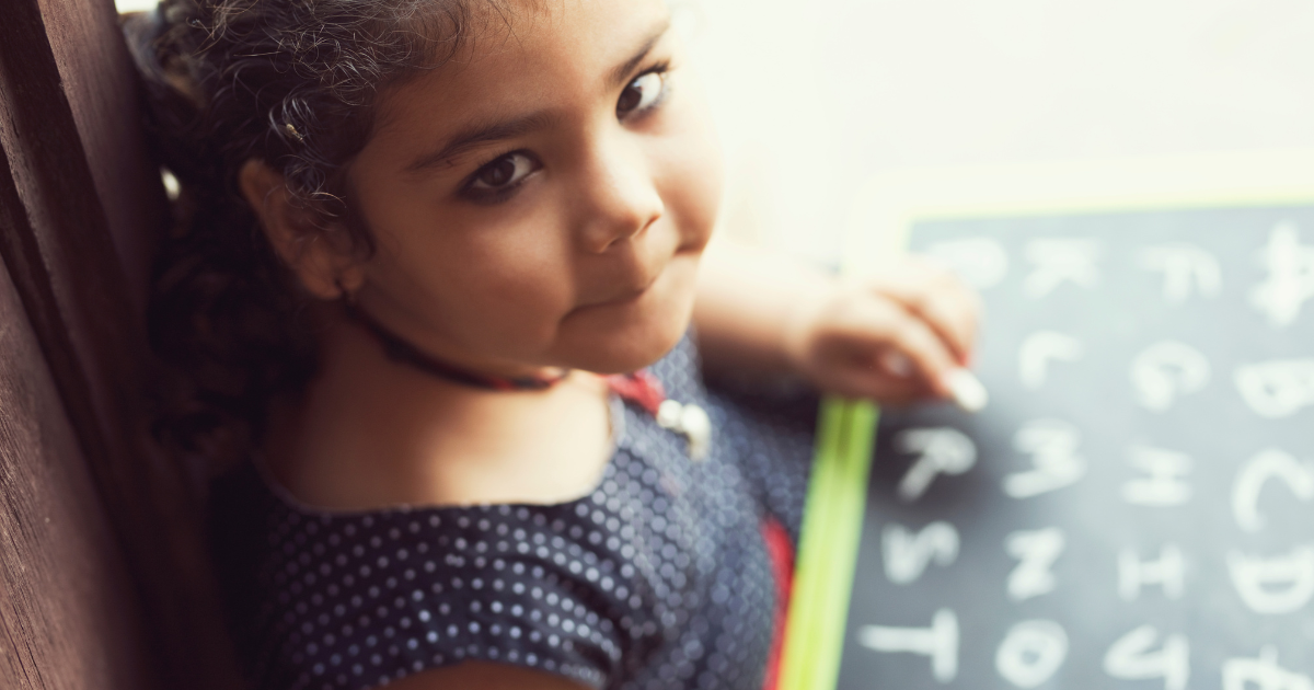 Girl writing the alphabet