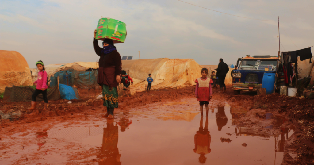 A displaced woman and child in a refugee camp